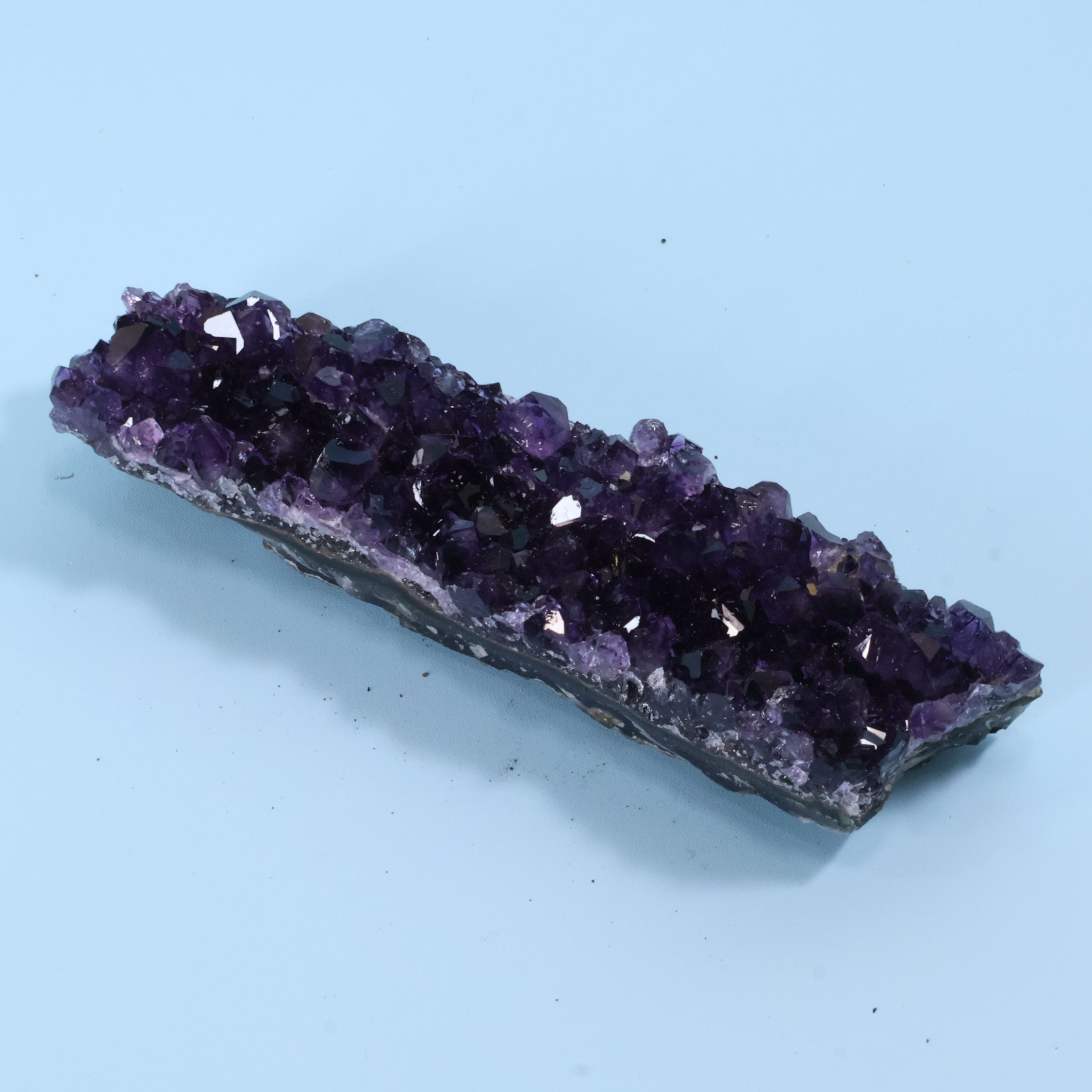 Amethyst crystal on a light blue background