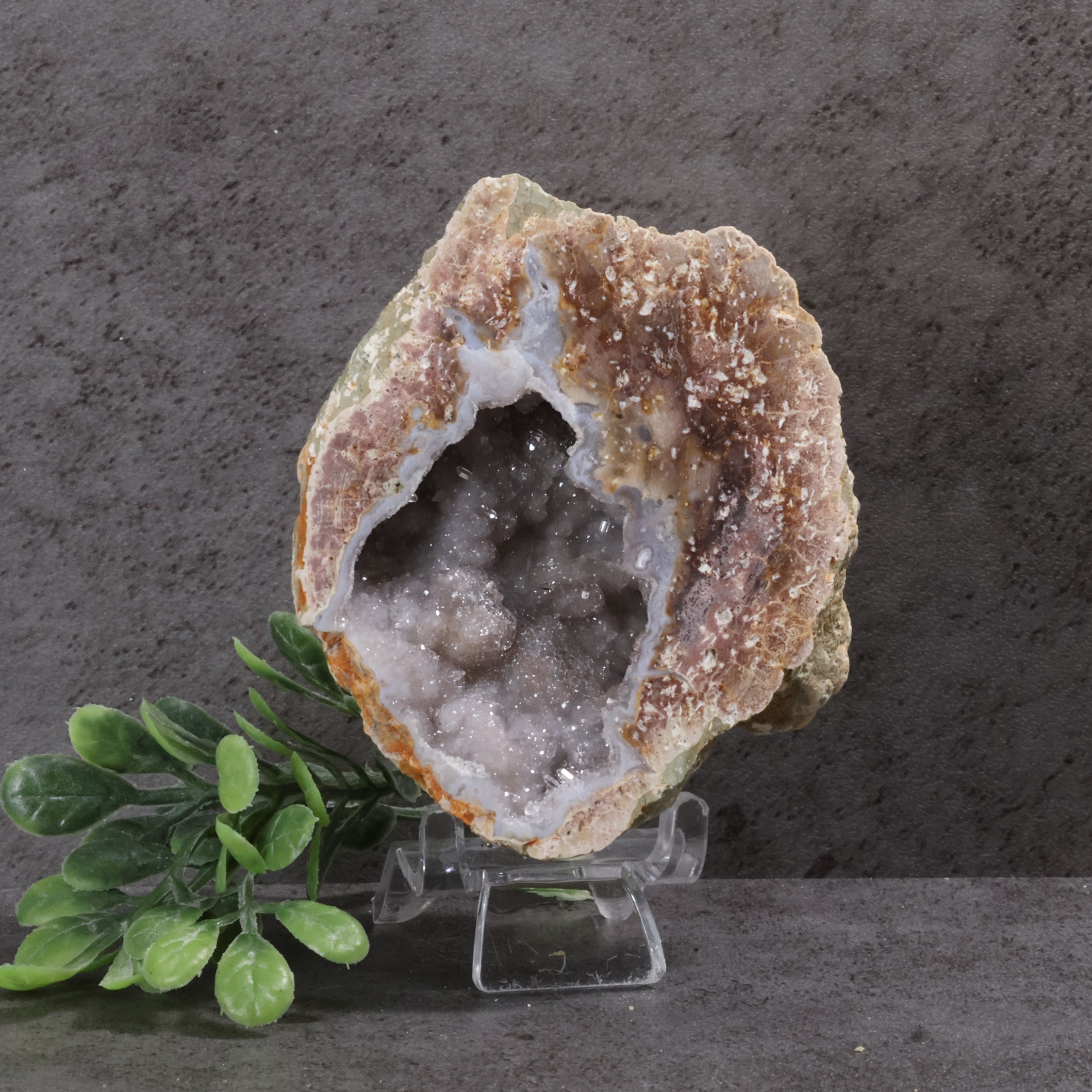 Geode crystal on a stand with a dark gray background