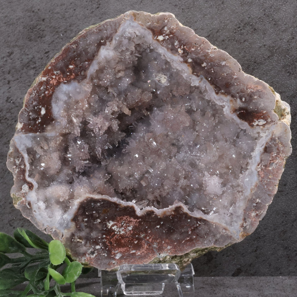 Geode crystal on a stand with a dark gray background