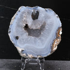 Geode slice on a stand against a black background