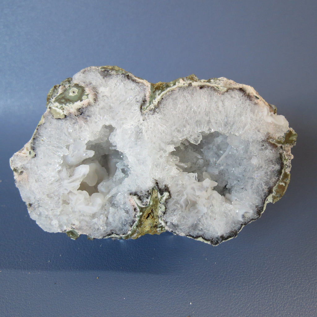 Geode with crystal formation on a blue background
